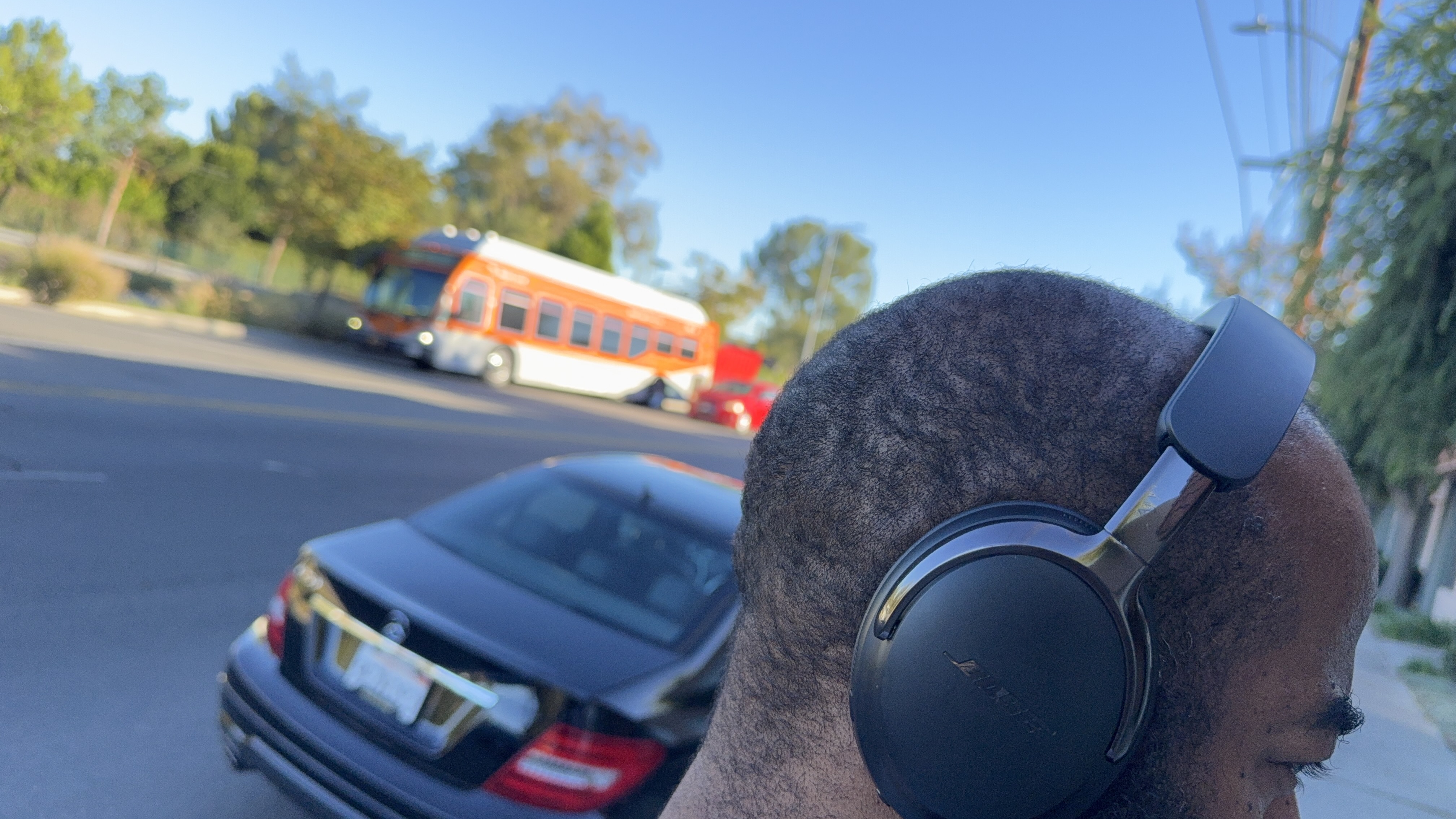 Bose QuietComfort Ultra Headphones (2nd Gen) being worn by reviewer, testing the ANC on a busy street