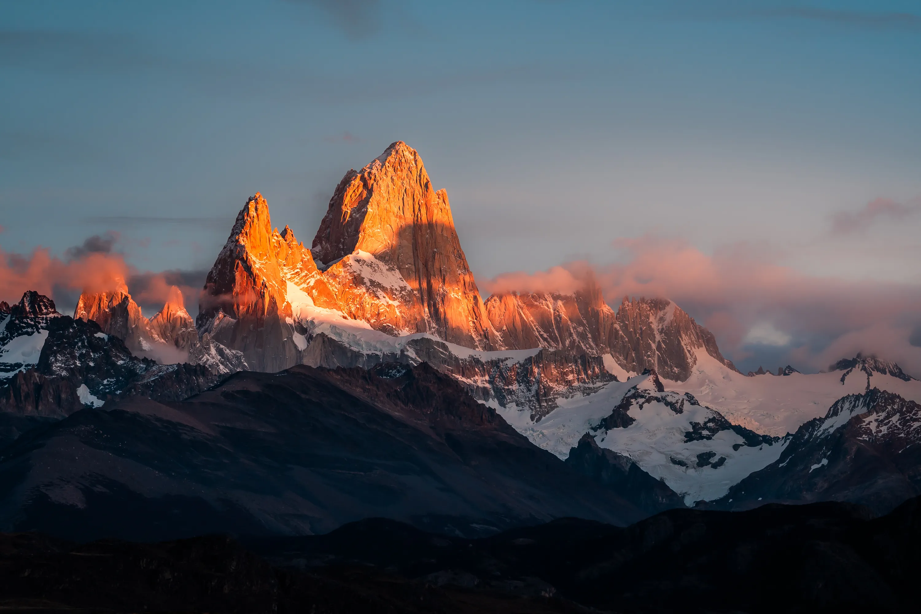 The visual climax of the series: the first light of dawn strikes the granite walls of Mount Fitz Roy, creating a crimson glow that lasts only a few seconds before fading.