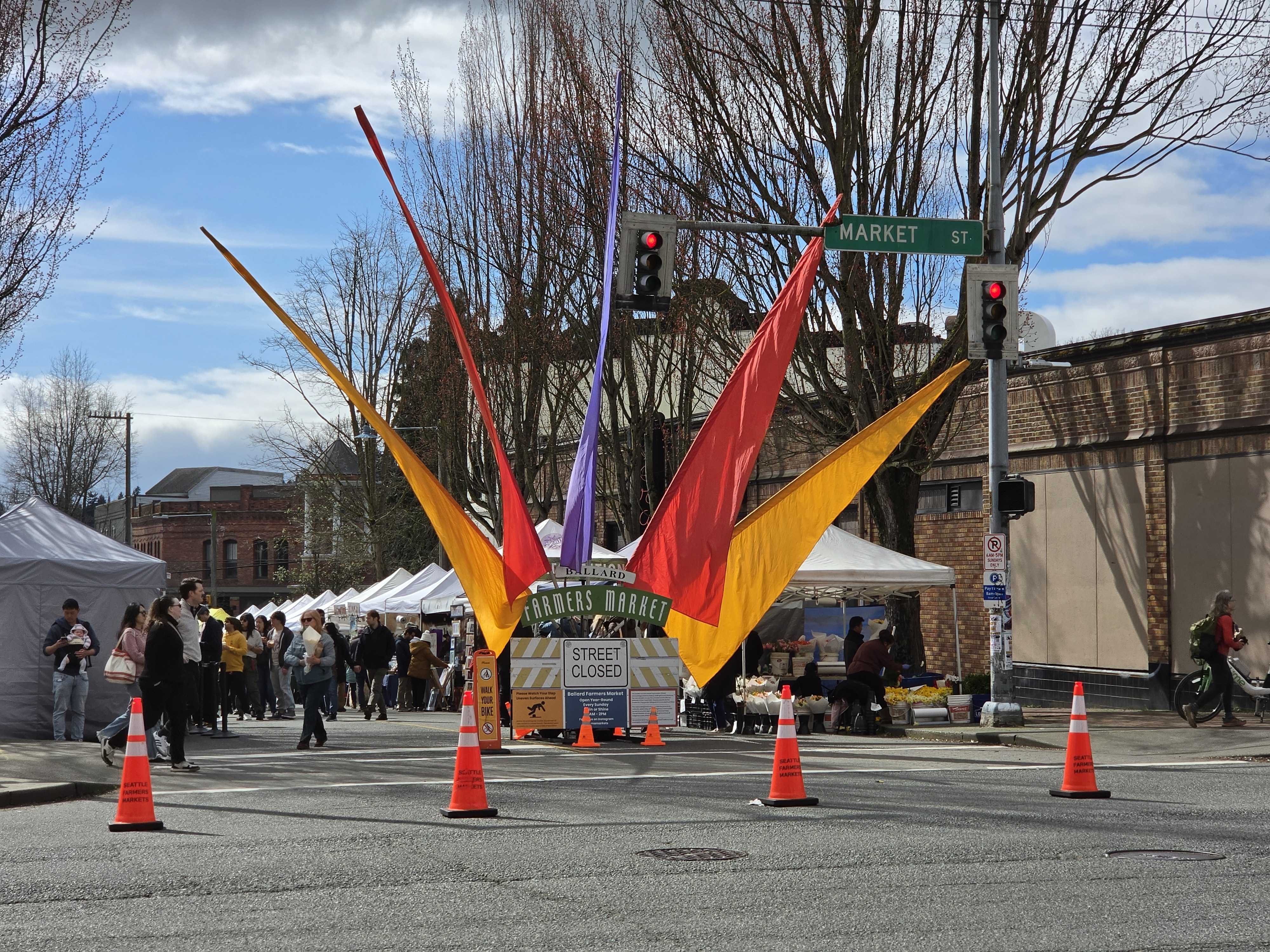 A sign with colorful flags on a street