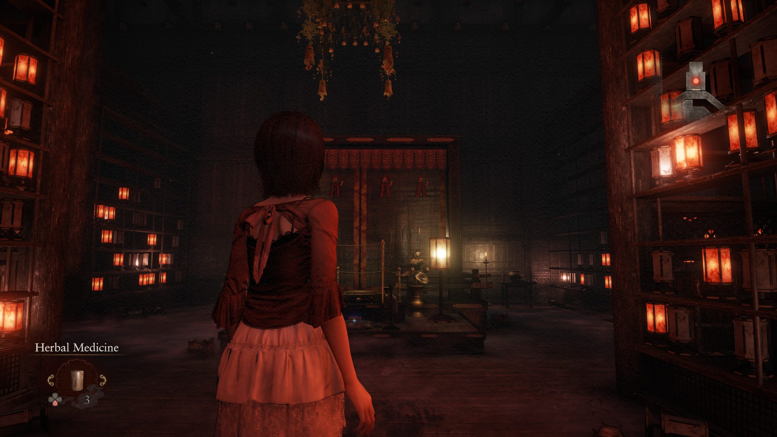 A character in Fatal Frame 2 Crimson Butterfly Remake stands in a dimly lit room with shelves of lanterns and the text 'Herbal