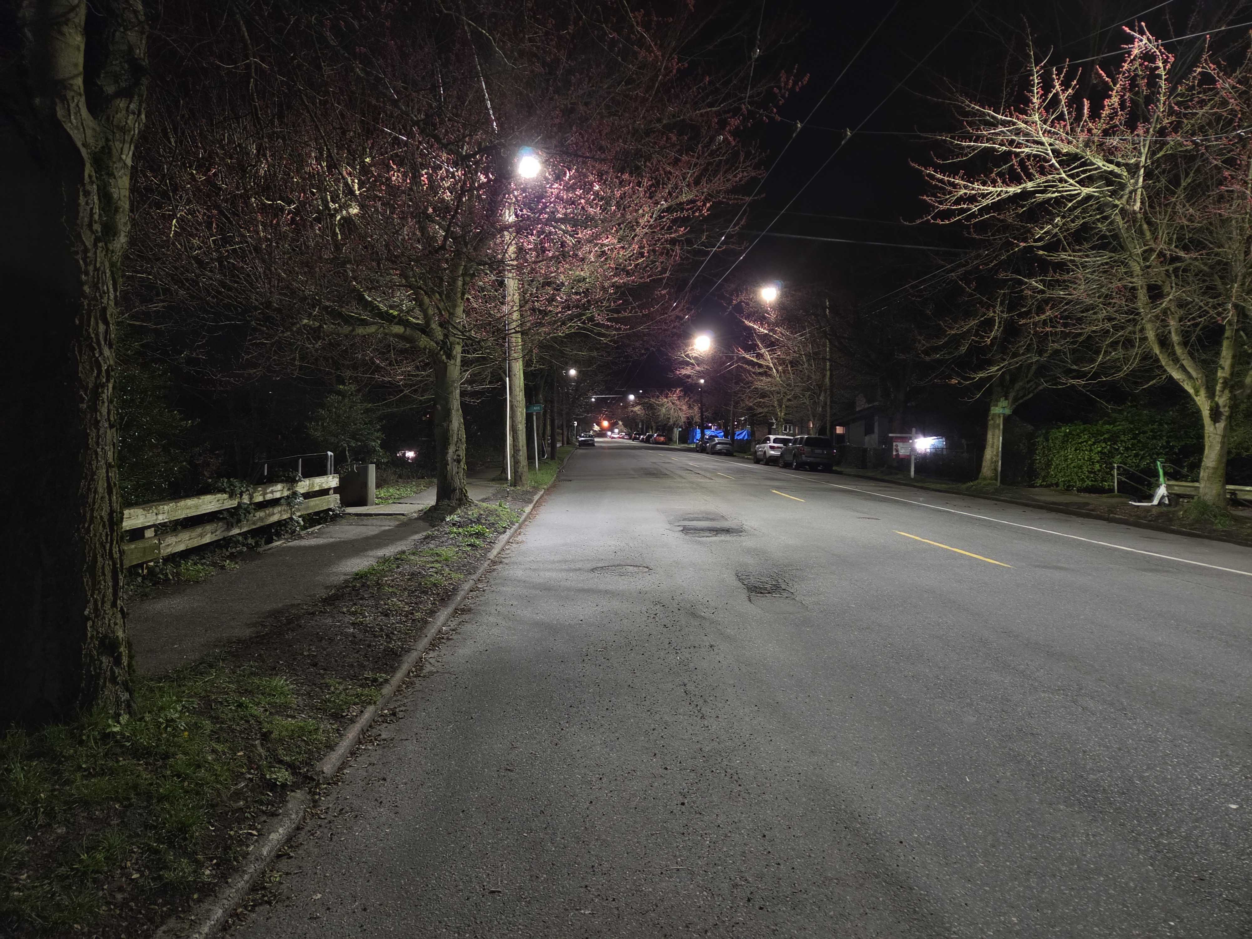 A dark street lit by street lamps